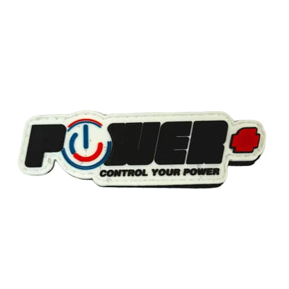 A rectangular sticker with the word 'POWER' in bold black letters outlined in white, featuring a red power symbol inside the O and a small red mark on the right. Below the main word, the phrase 'CONTROL YOUR POWER' appears.