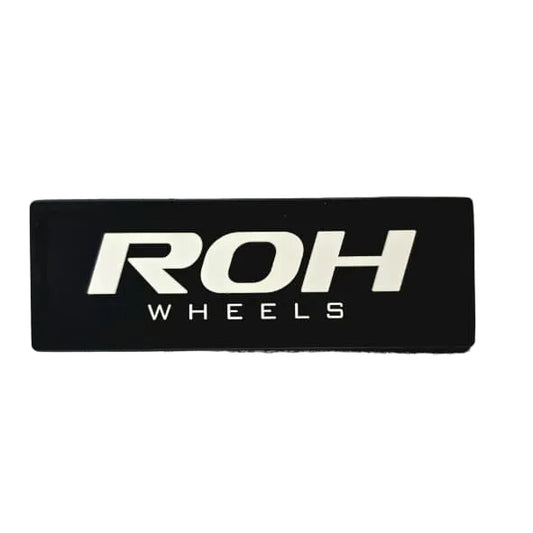 A Rectangular ROH Wheels PVC Patch to be used on your vehicle roof liner, backpack or jackets